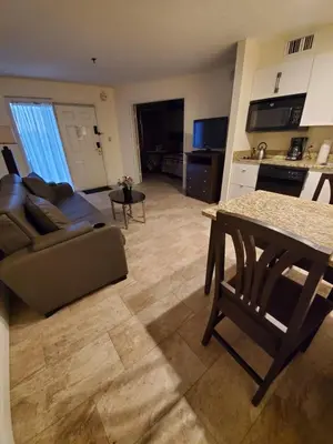 a living room with a couch and a table at Nice 2 Miles from DISNEY Condo 1 Bedroom 1 Bath in Orlando