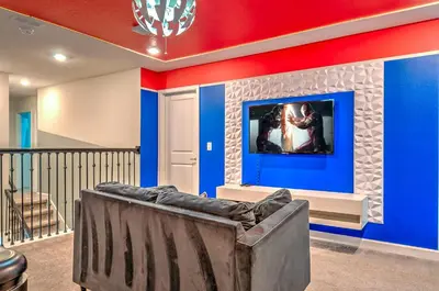a living room with blue and red walls and a couch at 2852 Ultimate Retreat for your family 9 Bedrooms in Kissimmee