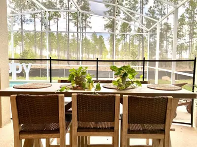 a table in a glass house with two plants on it at Luxury 6 Bedroom 5 bath poolHome 214 in Orlando