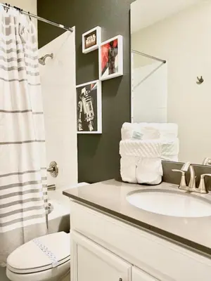 a bathroom with a sink and a toilet and a mirror at Luxury 6 Bedroom 5 bath poolHome 214 in Orlando