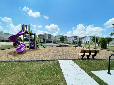 a playground with a purple slide in a park at Luxury 6 Bedroom 5 bath poolHome 214 in Orlando