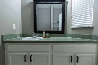 a bathroom with a sink and a mirror at Cozy Family 3BR Townhouse Perfect Stay for 6 Guests in Kissimmee