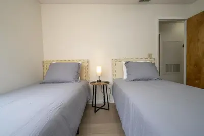 two beds sitting next to each other in a bedroom at Family Apt very close to Disney in Kissimmee