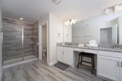 a bathroom with a shower and a sink and a toilet at Luxury 5 Bedroom 5 bath private pool Home 279 in Kissimmee