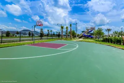 a basketball court in a park with a basketball hoop at Luxury 4 bedroom 3 bath pool Home 264 in Kissimmee