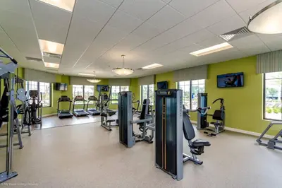a gym with treadmills and elliptical machines at Luxury 4 bedroom 3 bath pool Home 264 in Kissimmee