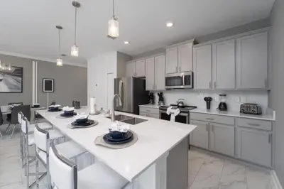 a kitchen with white cabinets and a white counter top at Luxury 4 bedroom 3 bath pool Home 271 in Kissimmee
