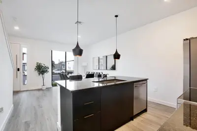 a kitchen with white walls and a black counter top at Brand new townhouse in The Hub in Kissimmee