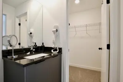 a bathroom with a sink and a mirror at Brand new townhouse in The Hub in Kissimmee