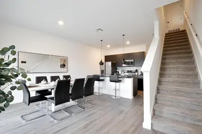 a kitchen and dining room with a table and chairs at Brand new townhouse in The Hub in Kissimmee