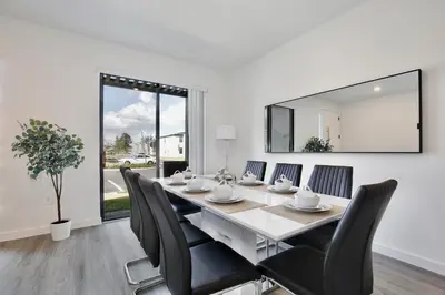 a dining room with a table and chairs and a mirror at Brand new townhouse in The Hub in Kissimmee