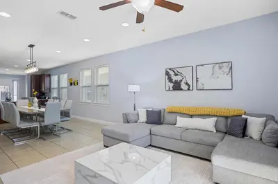 a living room with a couch and a dining room at Willow Cove in Orlando