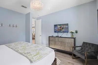 a bedroom with a bed and a chair at Willow Cove in Orlando