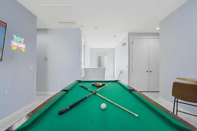 a pool table in a room with two cuesticks at Willow Cove in Orlando