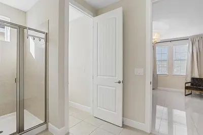 a bathroom with a shower and a glass door at Willow Cove in Orlando