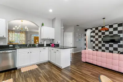 a kitchen with a pink couch in a room at The Colorful Cove in Orlando