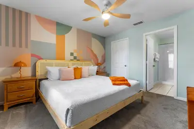 a bedroom with a bed and a ceiling fan at The Colorful Cove in Orlando