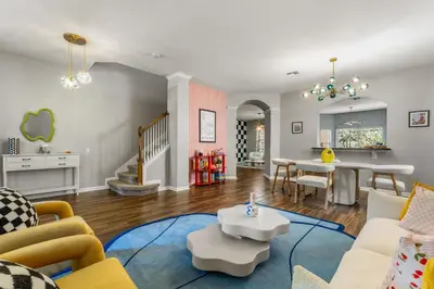 a living room filled with furniture and a dining room at The Colorful Cove in Orlando