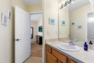 a bathroom with a sink and a mirror at Luxury Emerald Island Resort Villa with Stunning Pool Deck and Lake View Near Disney in Kissimmee