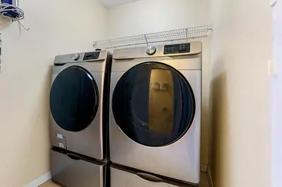 a washer and dryer sitting in a room at Luxury Emerald Island Resort Villa with Stunning Pool Deck and Lake View Near Disney in Kissimmee