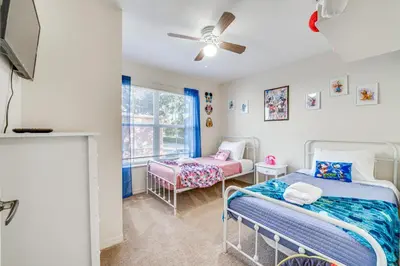 a bedroom with two beds and a window at 14 Mi to Disney World Kissimmee Condo with Perks! in Kissimmee