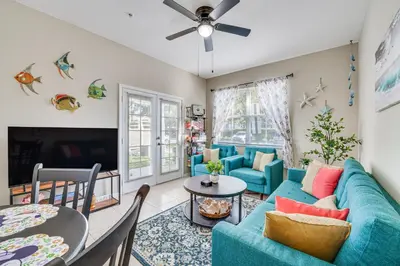 a living room with a blue couch and a table at 14 Mi to Disney World Kissimmee Condo with Perks! in Kissimmee