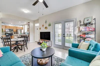 a living room with blue couches and a table at 14 Mi to Disney World Kissimmee Condo with Perks! in Kissimmee