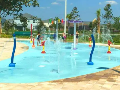 a water park with children playing in a fountain at Incredible Family Retreat with PS5 Private Pool and access to 2 Clubhouses in Kissimmee