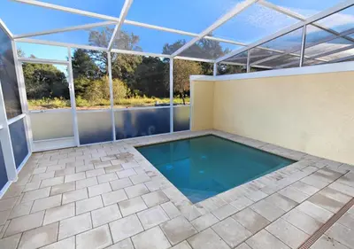 a swimming pool in a house with a glass roof at 17413 Luxury Pool Villa Serenity Haven, 3BR, Balcony in Orlando