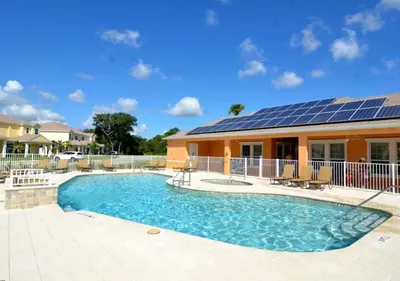 a house with a swimming pool with solar panels on it at 17413 Luxury Pool Villa Serenity Haven, 3BR, Balcony in Orlando