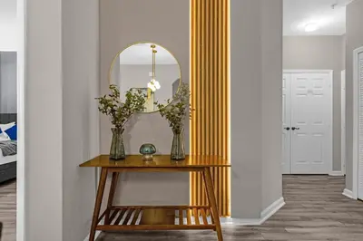 a dressing table with a mirror and flowers on it at 2306 SP - Disney Paradise 2BR Villa, Near Magic & More in Kissimmee