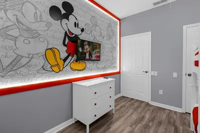 a bedroom with a mickey mural on the wall at 2306 SP - Disney Paradise 2BR Villa, Near Magic & More in Kissimmee