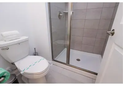 a bathroom with a toilet and a shower at 2489 RT Ultimate Villa Oasis with Pool & Spa Sleeps 13 in Kissimmee