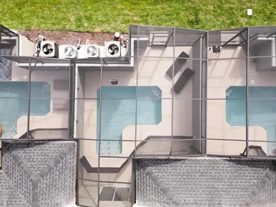 an external view of a building with a glass facade at 4BR Villa Private Pool - 11 Guests - Ultimate Family Adventure Awaits in Kissimmee