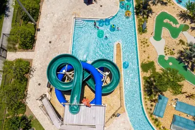 an overhead view of a pool with a water slide at 2604 - Luxury 4-BR Villa with Private Pool Retreat in Kissimmee