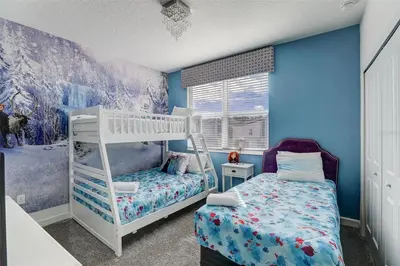 a bedroom with a bunk bed and blue walls at 2940 - Elegant 5BR Villa at Storey Lake Resort Comfort Luxury and Proximity Disney and Universal in Kissimmee