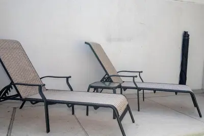three chairs sitting in a room next to a wall at Opulent 5 BR Villa Private Pool - 12 Guests - 3085 TS in Kissimmee