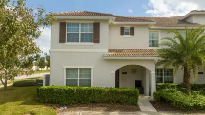 a house with a palm tree in front of it at Opulent 5 BR Villa Private Pool - 12 Guests - 3085 TS in Kissimmee