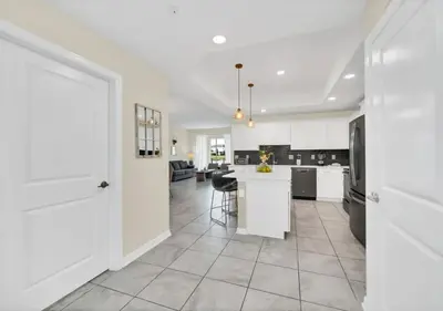 a kitchen with white cabinets and a white counter top at Luxury 3-Bed Condo in Storey Lake Resort - 3131 in Kissimmee