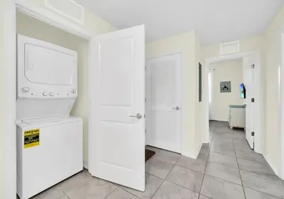 a white laundry room with a washer and dryer at Luxury 3-Bed Condo in Storey Lake Resort - 3131 in Kissimmee
