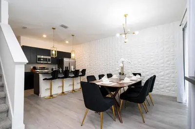 a dining room with a table and black chairs at Luxury 3 Bed Home up to 8 guests- The Hub - 3236 TT in Orlando