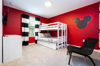 a red room with a bunk bed and a chair at Luxury 3 Bed Home up to 8 guests- The Hub - 3236 TT in Orlando