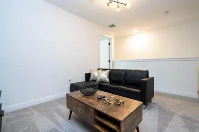 a living room with a black couch and a coffee table at Luxury 3 Bed Home up to 8 guests- The Hub - 3236 TT in Orlando