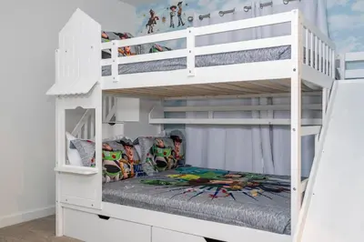 a white bunk bed in a childs bedroom at 3258 SW - Luxury Getaway The Hub Relax and Enjoy a Serene Vacation Retreat in Kissimmee