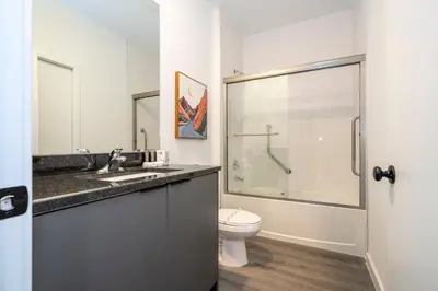 a bathroom with a toilet and a sink and a shower at 3258 SW - Luxury Getaway The Hub Relax and Enjoy a Serene Vacation Retreat in Kissimmee