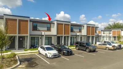 a parking lot with cars parked in front of a building at 3258 SW - Luxury Getaway The Hub Relax and Enjoy a Serene Vacation Retreat in Kissimmee