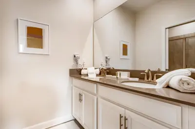 a bathroom with a sink and a mirror at Stunning 6BR Home, Private Pool & Spa - 14 Guests - 4507 NL in Kissimmee