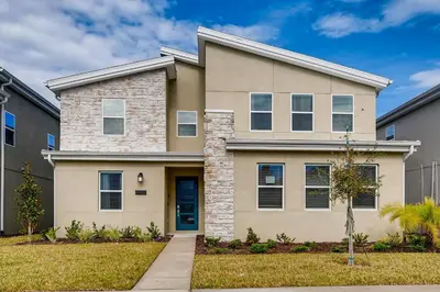 a large house with a blue door at Stunning 6BR Home, Private Pool & Spa - 14 Guests - 4507 NL in Kissimmee