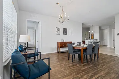 a dining room and living room with a table and chairs at 4816 Cayview Avenue 407 in Orlando