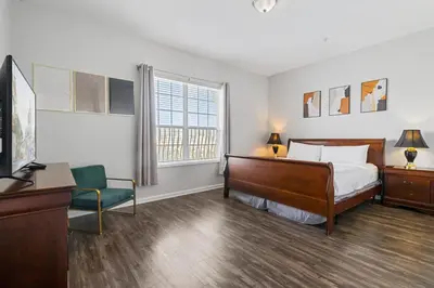 a bedroom with a bed and a desk and a tv at 4816 Cayview Avenue 407 in Orlando